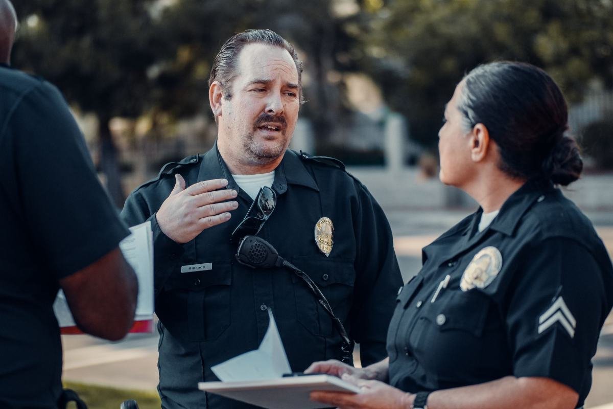 Two police officers discussing a report together